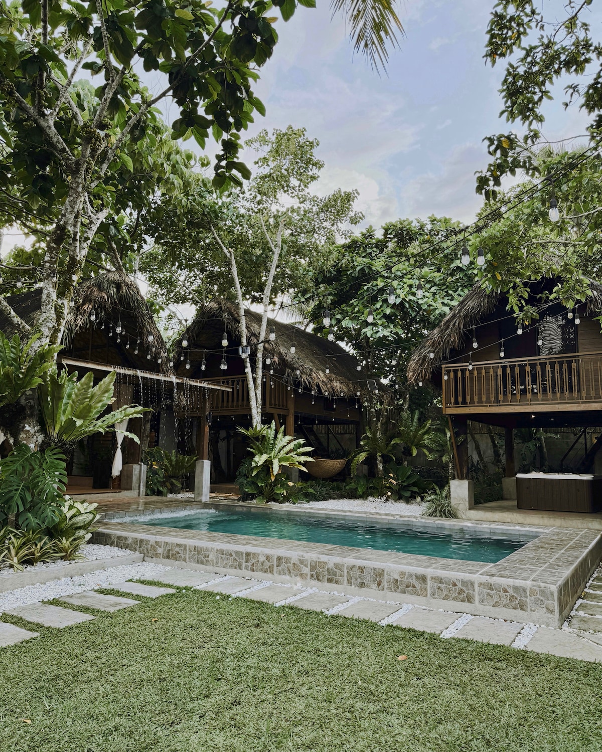 Amadeo villa pool and garden with string lights