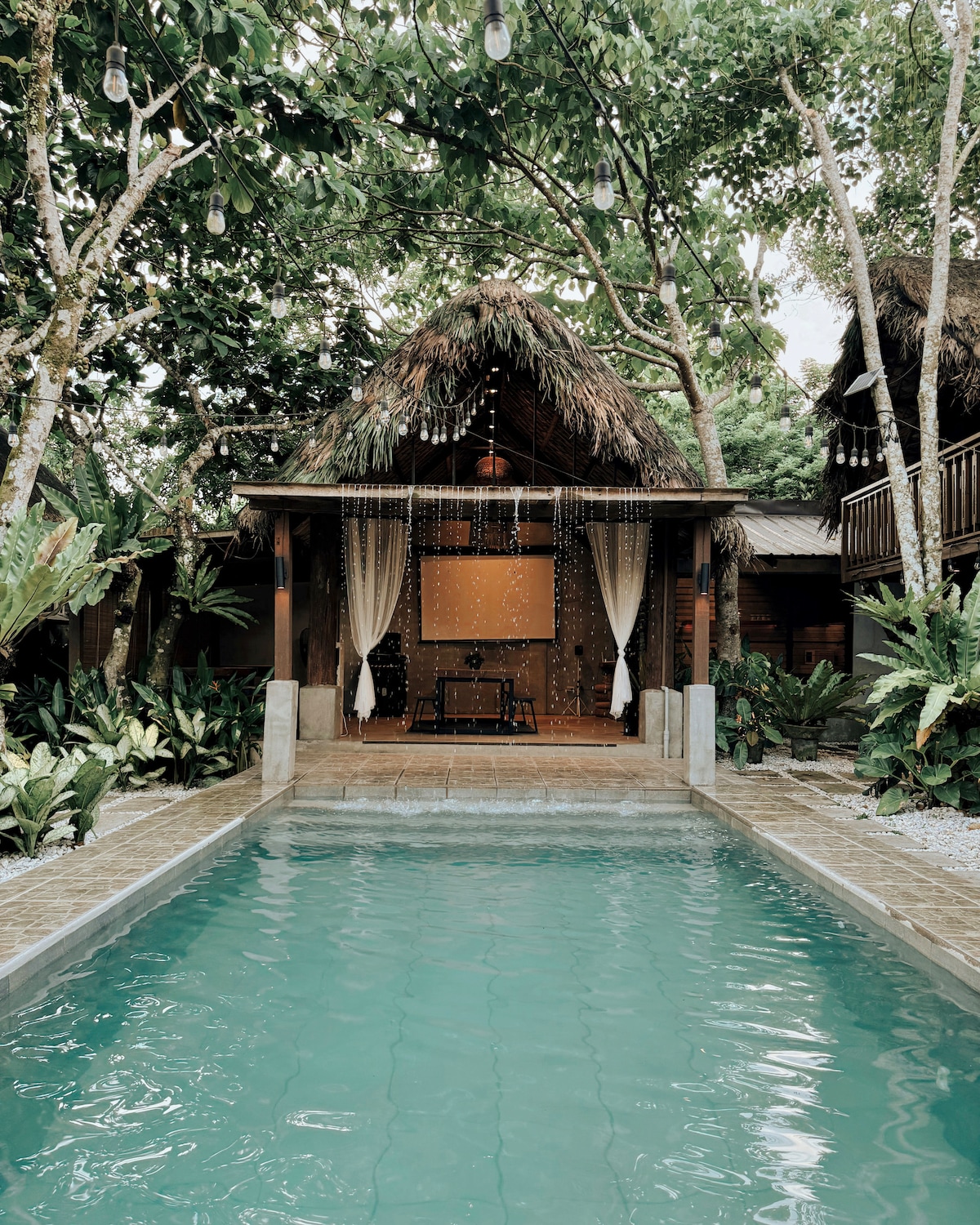 Pool and thatched cabana at Amadeo villa