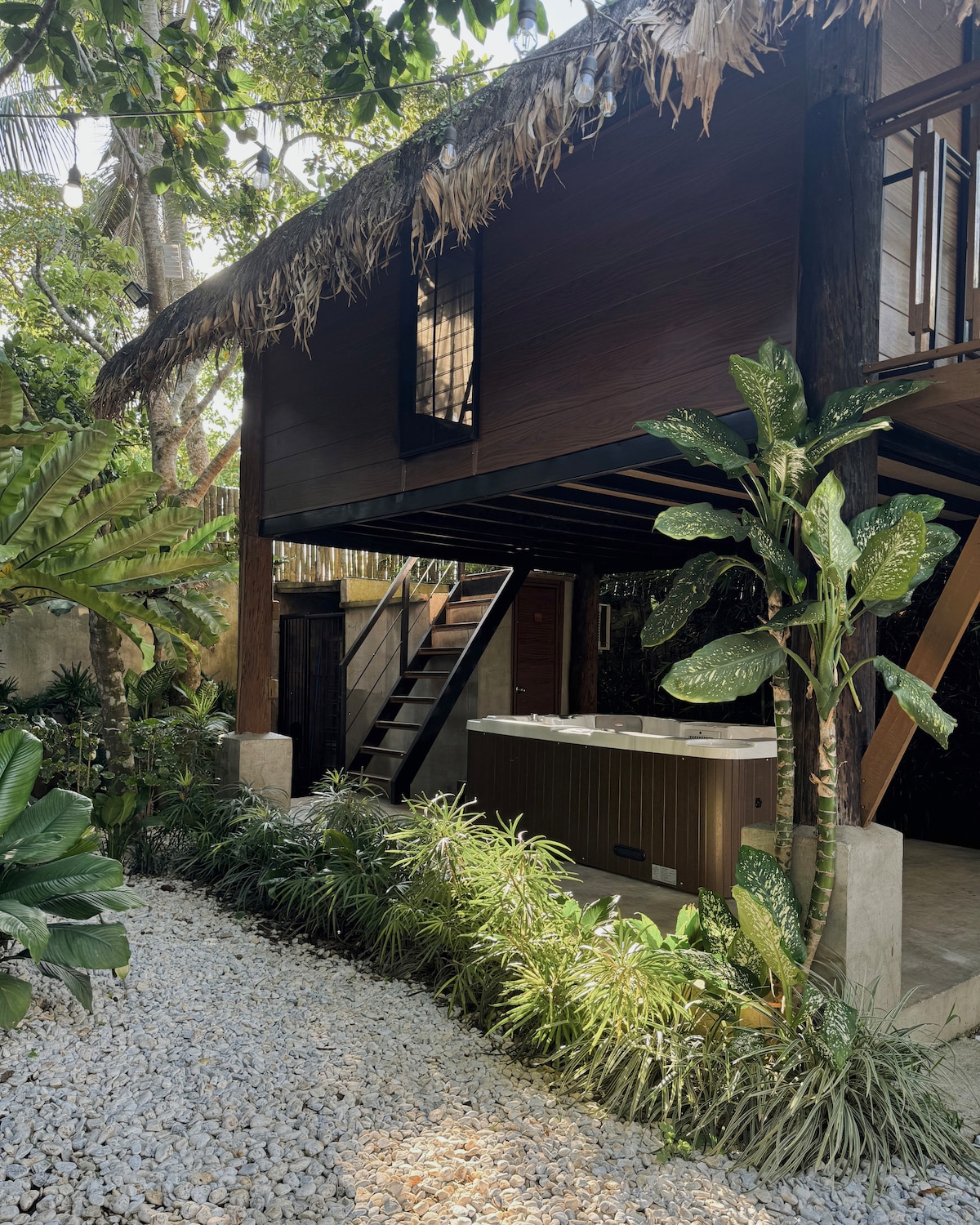 Villa exterior with hot tub and tropical landscaping